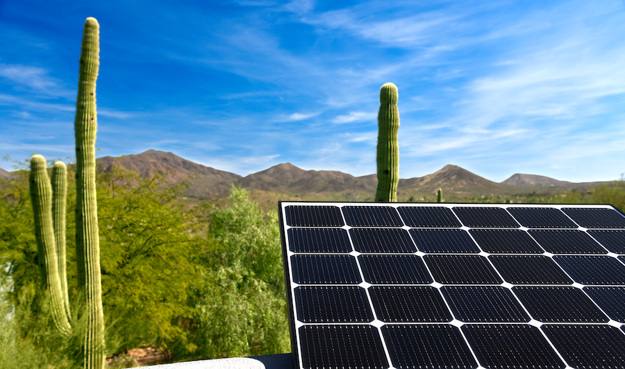 solar panel in foreground with saguaros in background